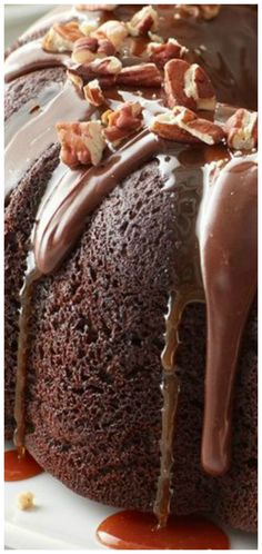 a chocolate bundt cake with nuts on top