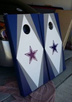 two cornhole game boards with stars on them