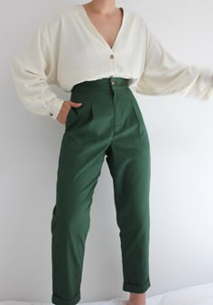 The Oliver Pant is an everyday go-to pant that features a flattering classic high waist, side seam pockets, front pleat detailing, and a cuffed straight tapered leg. This hero fabric is comparable to the feel of vintage khaki chinos; lightweight, and substantial, with that already broken-in feel. One of the first original Na Nin designs, coveted and beloved by many - we're pleased to reintroduce our Oliver Pants in beautiful french cotton twill with updated sizing and grading in this beautiful f Classic High-waist Chinos For Workwear, High Waist Green Cargo Pants For Workwear, Classic High Waist Chinos For Work, Classic High Waist Chinos With Belt Loops, High Waist Khaki Dress Pants For Work, Chic Tapered Leg Chinos For Workwear, Tapered Chinos For Workwear, Khaki High-waisted Pants For Work, High-waisted Chinos For Work