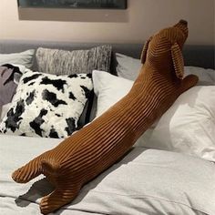 a large brown dog laying on top of a bed