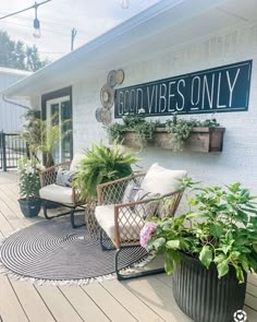 a porch with chairs and potted plants on the side of it that says god vibes only