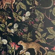 a painting of a leopard and other animals on a black background with green leaves, flowers, and branches