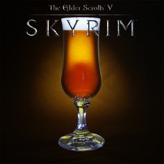 a glass filled with liquid sitting on top of a black table next to the words skyrim