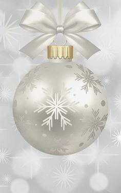 a silver christmas ornament with snowflakes and a bow hanging from it