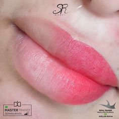 a person with pink lipstick on their face and the bottom half of her lip showing