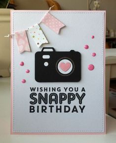 a birthday card with a camera and confetti