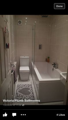 the bathroom is clean and ready for us to use it's bathtub, toilet, shower head, and rugs