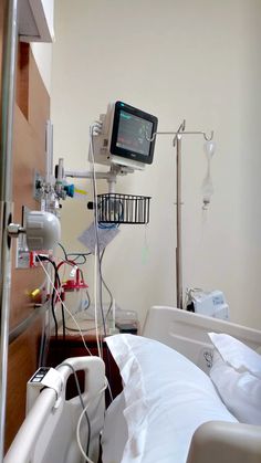 a hospital room with an iv and monitor