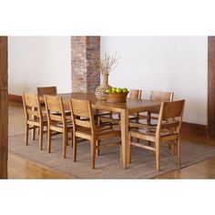 a dining room table with chairs and fruit on top of it in front of a brick wall