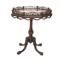 an ornately carved wooden table with glass top