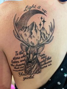 a woman with a deer tattoo on her back