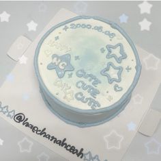 a white cake with blue frosting and stars on it