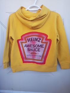 Heinz awesome sauce, ketchup style back patch on mustard colored pullover hoodie, super soft and perfect for your little ketchup lover. 2 small marker dot stains on the sleeve - pictured in photo. ALL PATCHES ARE FABRIC GLUED AND HAND SEWN. Urban Heritage Youth brand Size 10/12 Reworked Sweater, Awesome Sauce, Fabric Glue, Back Patch, Ketchup, Kids Sweatshirt, Hand Sewn, Hand Sewing, Pullover Hoodie