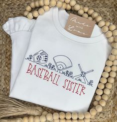 Hey, batter batter! This baseball shirt is perfect for your favorite little fan! This design looks great with or without a monogram! When ordering an embroidered item, please specify your monogram initials or name, monogram font & thread color. All of the monogram options can be found here. Also, please note any special requests in the box provided. We will try our best to comply. Personalized White Sporty T-shirt, Personalized Cotton T-shirt For Game Day, Embroidered School Spirit Tops For Game Day, School Spirit Embroidered Tops For Game Day, Collegiate White Tops With Custom Embroidery, White Collegiate Top With Custom Embroidery, Personalized Game Day Tops With Team Spirit, White T-shirt With Embroidered Graphics For Game Day, White Varsity T-shirt With Embroidered Graphics