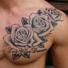 a chest tattoo with two roses and the words live your dreams