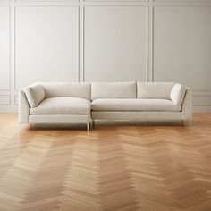 a white couch sitting on top of a hard wood floor