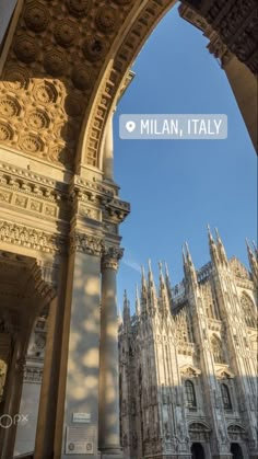 an arch with the words, milan, italy on it in front of a cathedral