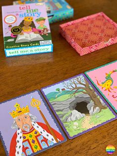 children's books and cards on a table with an open book in the background