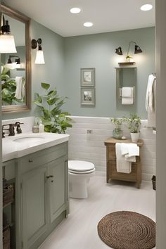 a bathroom with green walls and white tile on the floor, along with a rug