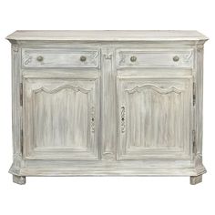 an old white cabinet with two doors and drawers