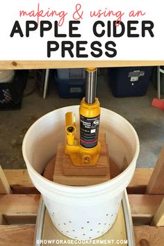 an apple cider in a bucket with the words making and using an apple cider press