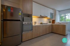 a modern kitchen with stainless steel appliances and wood cabinets