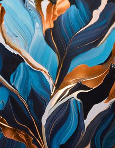 a close up view of some blue and gold leaves