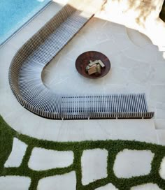 an outdoor swimming pool with grass on the ground