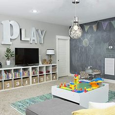 a playroom with chalkboard walls and toys on the floor