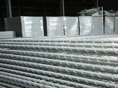 several stacks of white plastic bags sitting next to each other on top of a metal rack