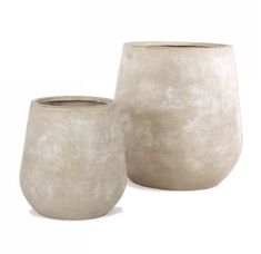 two white vases sitting next to each other