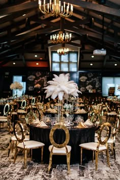 the tables are decorated with gold chairs and white centerpieces, along with black table cloth