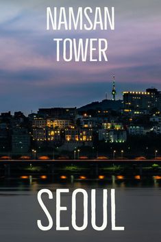 the words seoul are lit up in front of a cityscape