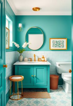 a bathroom with blue walls and gold accents on the vanity, toilet and sink area