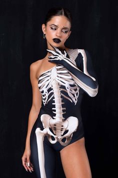 a woman in a skeleton bodysuit posing for the camera with her hands on her hips