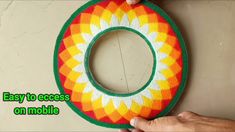 someone is holding up an easy to crochet wreath on the wall with text overlay that reads, easy to access on mobile