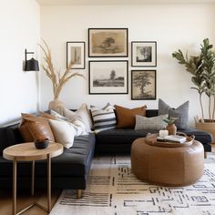 a living room filled with lots of furniture and pictures on the wall above it's coffee table