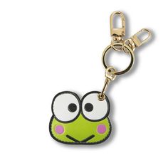 a keychain with a green frog face on it's front and back sides