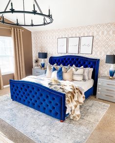 a bed with blue velvet headboard and foot board