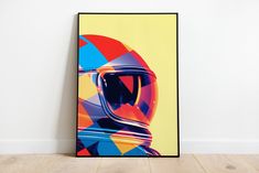 a poster with a helmet on it in front of a white wall and wooden floor