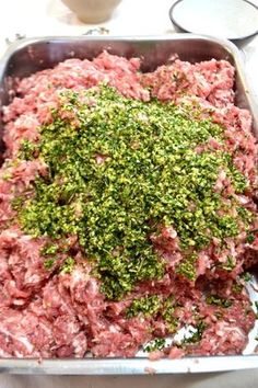 raw ground meat in a metal pan with parsley on top