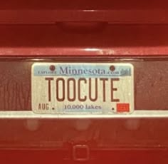 a minnesota license plate that says toocute on it's front bumper sticker