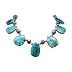 Introducing our captivating creation: the Dramatic and Bold Chrysocolla Oval Plates Necklace, a true one-of-a-kind masterpiece. Crafted with meticulously polished Chrysocolla plates, each exuding its unique allure, this necklace is a celebration of natural elegance. Enhanced with lustrous green freshwater pearls and accented with the richness of vermeil, every element in this piece speaks of luxury and sophistication. Fastened securely with a clasp fashioned from vermeil and Chrysocolla, this ne Cartier Panthere, Robert Lee, Bracelet Love, Oval Plates, Plate Necklace, Gio Ponti, Keith Haring, John Galliano, Donna Karan