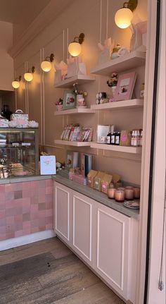 the inside of a store with shelves and lights