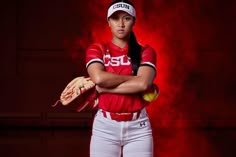 a female baseball player is posing for a photo