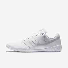 the nike tennis shoe is white and has a perfored upper part that matches the rest of the shoe