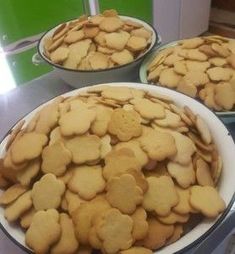 two bowls filled with cookies sitting on top of a counter