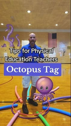 a man standing on top of a basketball court with an octopus tag in front of him