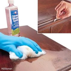 a person with blue gloves cleaning a wooden table