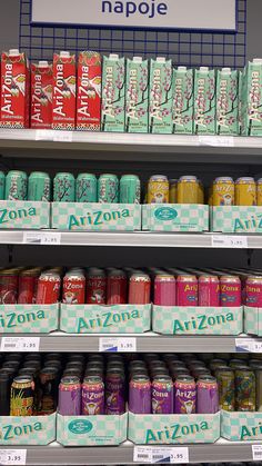 cans of arizona tea are on shelves in a store